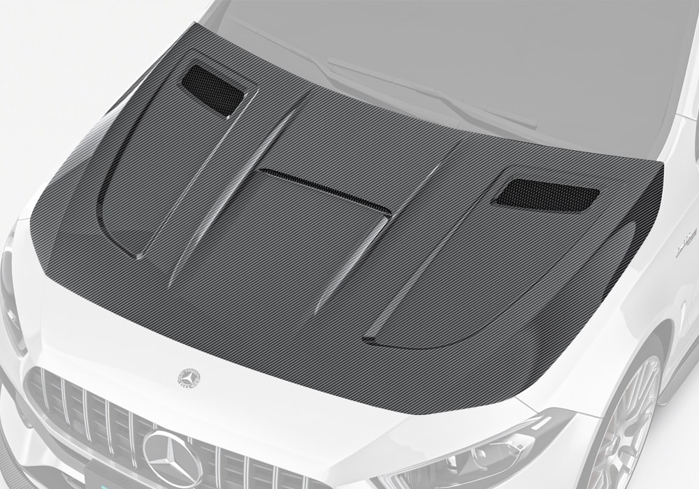 A bold front-angle shot showcasing the seamless fit and aggressive styling of the Carbon Fiber Hood on the A-Class W177