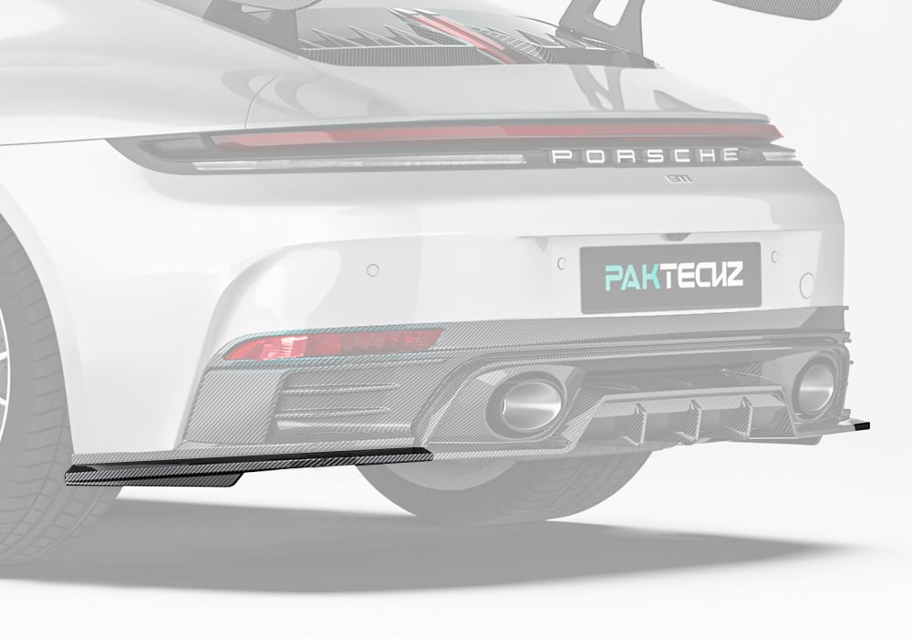 A full rear-side profile photograph showing the Carbon Fiber Rear Side Splitters integrated seamlessly into the Porsche 911 rear bumper design