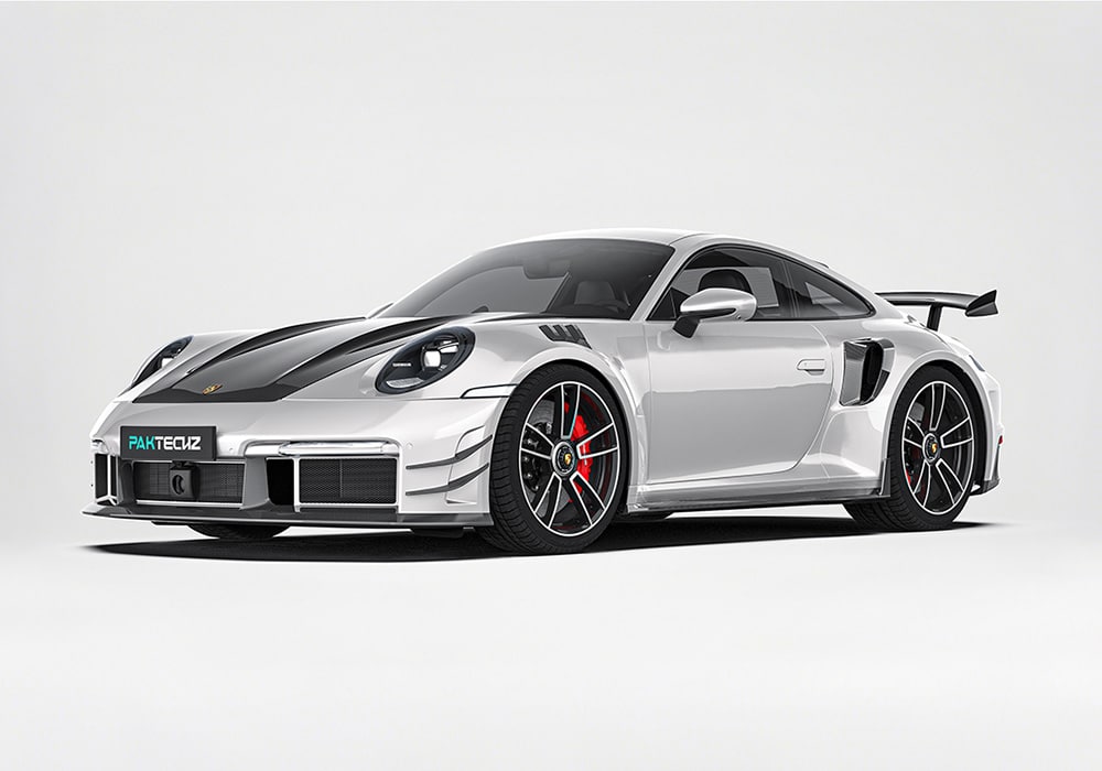 The Porsche 992 Turbo S featuring the full Carbon Fiber Aero Kit, showcasing its aggressive styling upgrades including the front lip and side skirts.