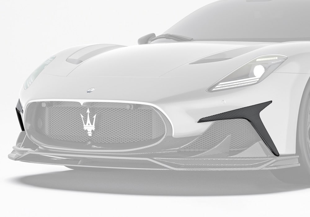 A striking front-end image of the Maserati MC20 showcasing the carbon fiber front canards, highlighting their sleek integration and aggressive design