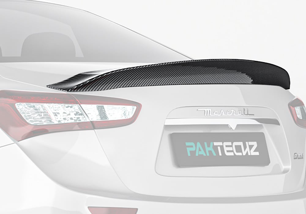 A stunning full-rear view of the Maserati Ghibli featuring the Carbon Fiber Rear Spoiler, accentuating the luxury sports design
