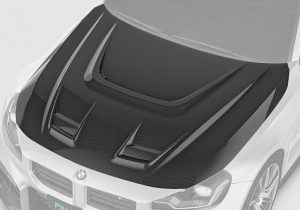 BMW M2 G87 equipped with the Carbon Fiber Hood, emphasizing its sleek, aggressive design seamlessly integrated with the vehicle’s body