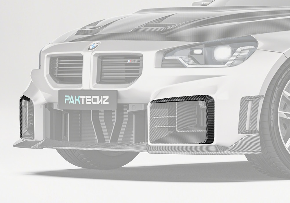 A detailed shot of the Carbon Fiber Front Canards installed on the BMW M2 G87, showcasing the premium carbon fiber weave texture and sleek design