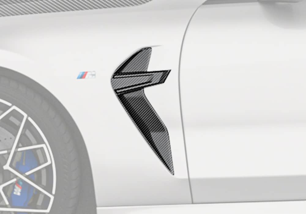 A complete side view of the BMW M8 F93, showcasing the Carbon Fiber Fender Trims as part of the overall luxurious and sporty look