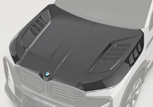A frontal image showcasing the BMW XM G09 with a sleek, well-integrated Carbon Fiber Hood, highlighting its aggressive styling