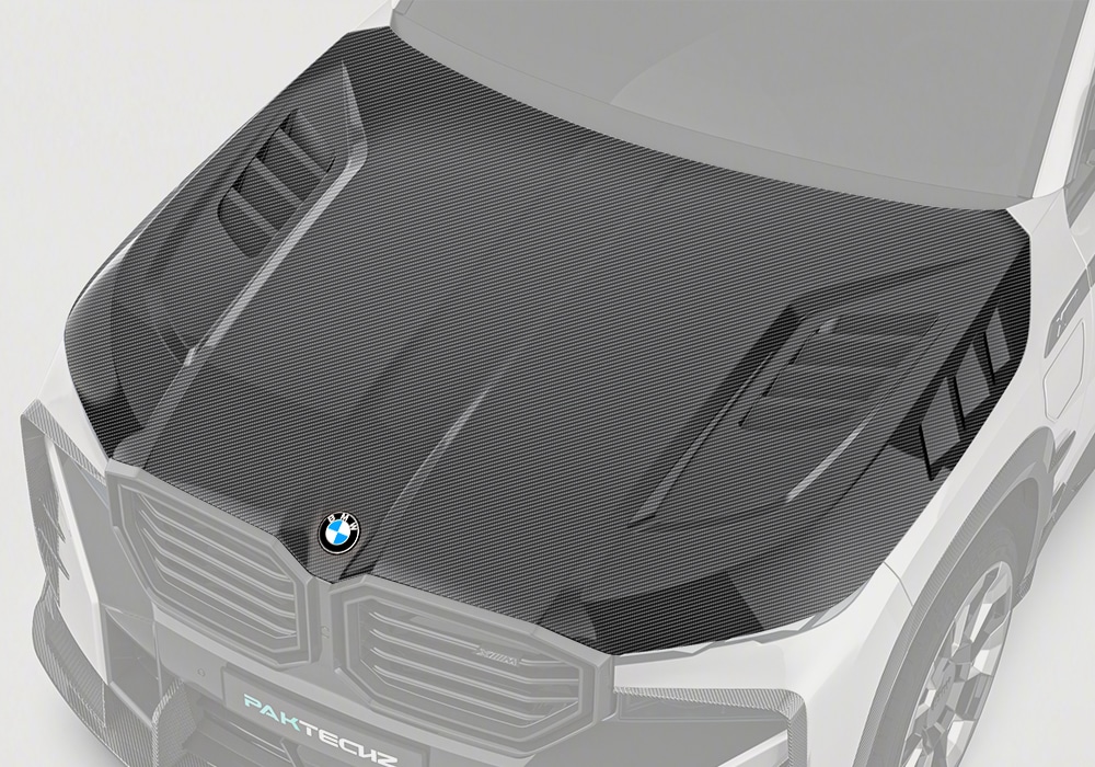 A frontal image showcasing the BMW XM G09 with a sleek, well-integrated Carbon Fiber Hood, highlighting its aggressive styling