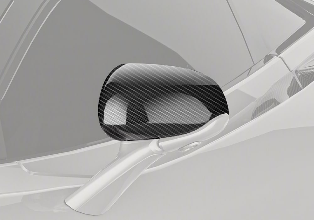 Close-up of McLaren 720S featuring Carbon Fiber Mirror Cove, showcasing a luxury carbon fiber finish