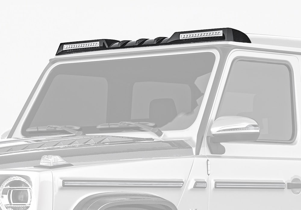 A detailed close-up of the aerospace-grade 2x2 twill carbon fiber material used in the front roof spoiler, highlighting its craftsmanship and premium finish