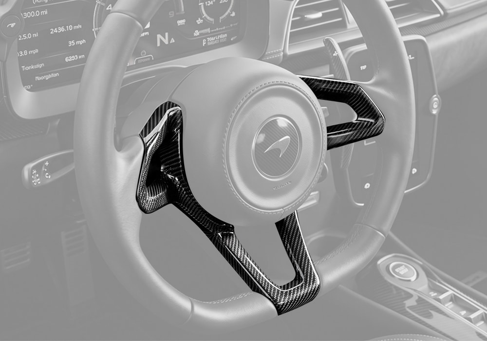 Close-up of McLaren Artura Carbon Fiber Steering Wheel Trim showcasing twill weave and premium gloss finish