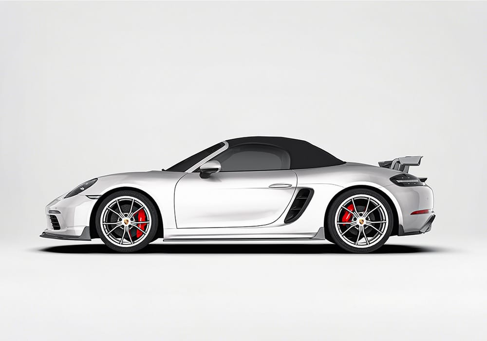 Highlight the carbon fiber weave and aerodynamic contour of the front splitter, illustrating how it reduces drag and enhances high-speed handling
