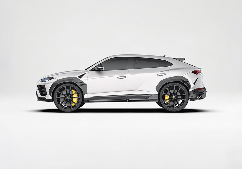 Full side profile of Lamborghini Urus, showcasing the carbon fiber side skirts, wheel arch covers, and door details
