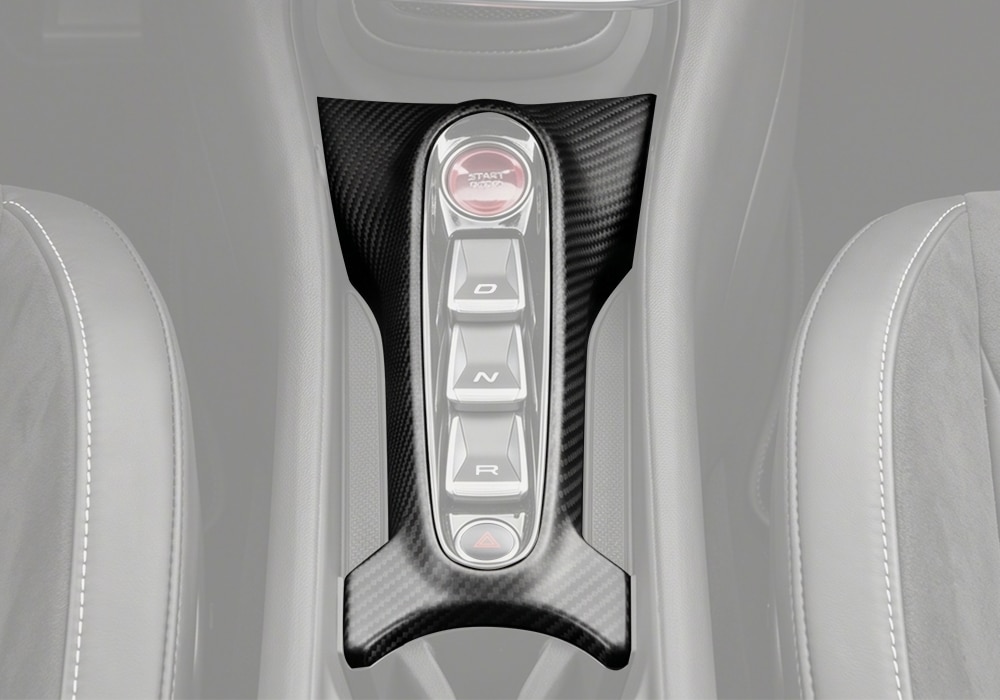 Close-up of McLaren Artura Carbon Fiber Console Gear Selector Panel, showcasing its fine 2x2 twill weave and gloss finish