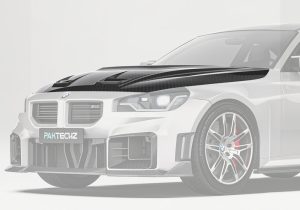 High-resolution image showcasing the premium carbon fiber weave, featuring precision-machined vents for improved engine cooling