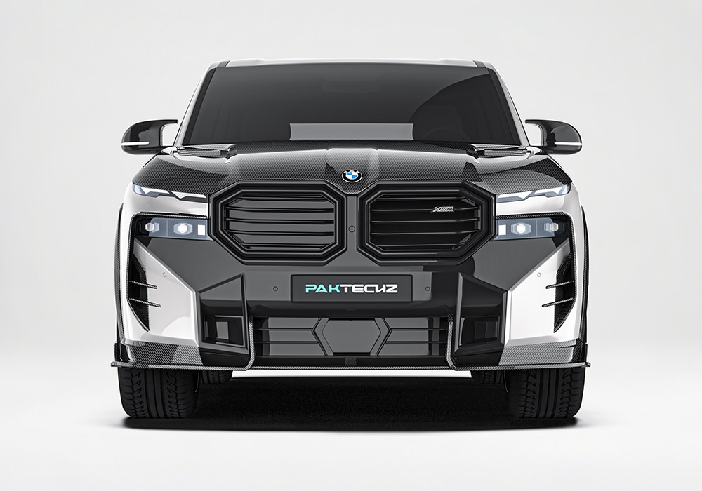 A detailed shot of the aerospace-grade carbon fiber front splitter, highlighting its textured surface and reflective finish