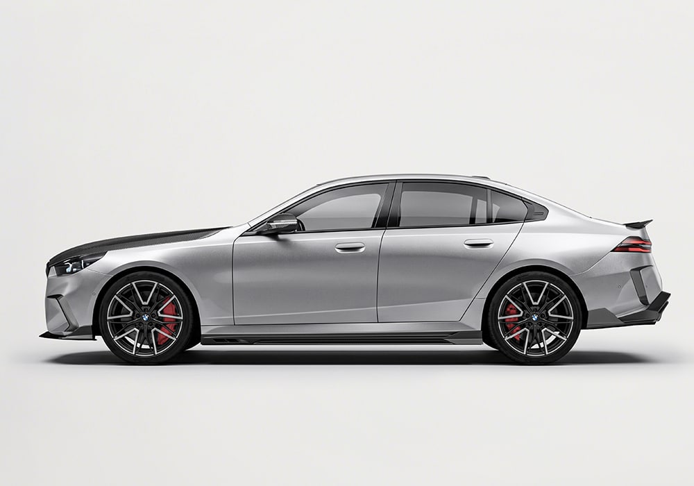 Rear view of BMW M5 (G90) showcasing the integrated carbon fiber diffuser and roof spoiler for a sport-inspired finish