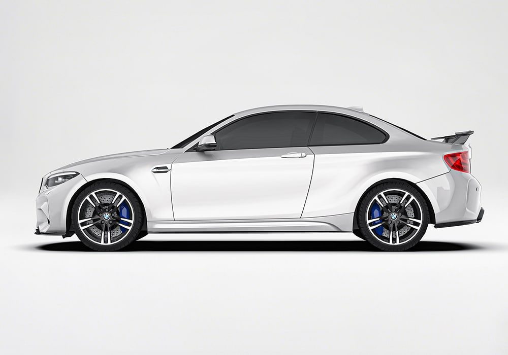 Side view of the BMW M2 equipped with carbon fiber side skirts, emphasizing improved airflow and dynamic styling