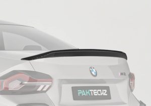 BMW M2 G87 with the Carbon Fiber Rear Spoiler cutting through the wind on a racetrack, showcasing its aerodynamic benefits