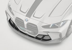 A side-angle photograph showing how the Carbon Fiber Front Vent Trim seamlessly aligns with the BMW M4's aerodynamic styling