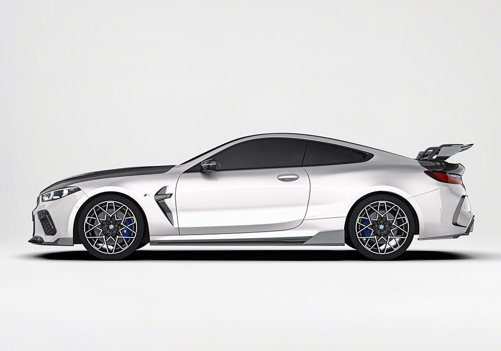 A side profile shot showing how the carbon fiber side skirts enhance the contour of the body and reduce turbulence along the sides of the BMW M8