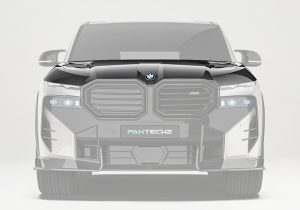 A side-angle shot of the BMW XM G09 hood showing the functional air vents that enhance cooling and improve airflow for performance