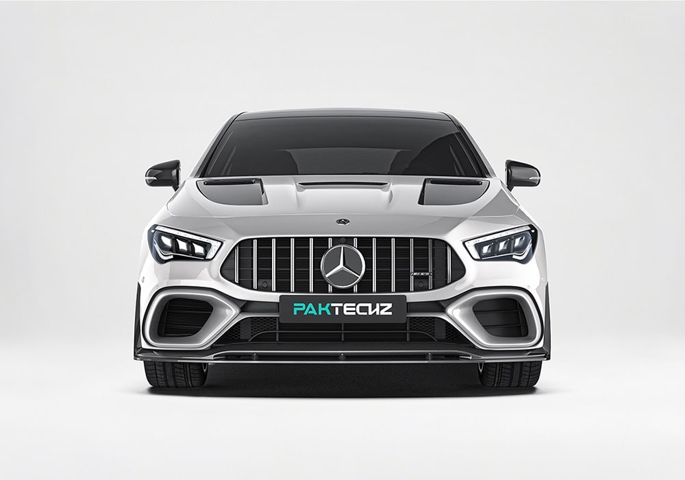 An action photo showcasing the CLA-Class W118 equipped with the aerodynamics kit, being driven on a mountain highway or track, emphasizing its sporty design and functional benefits