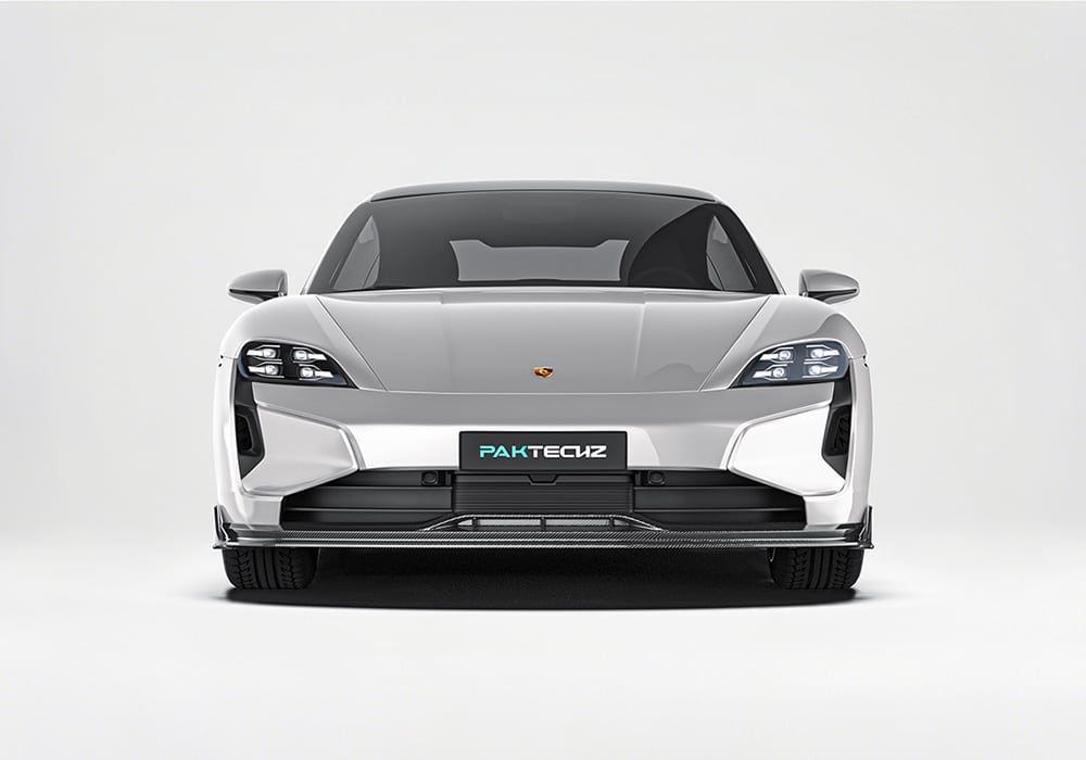 The Porsche Taycan fitted with carbon fiber side skirts, shown during high-speed driving to emphasize aerodynamic performance and side profile enhancements