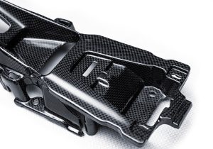 Studio image of the Ferrari F8 Carbon Fiber Center Console Bridge, showing its ergonomic and luxurious contours
