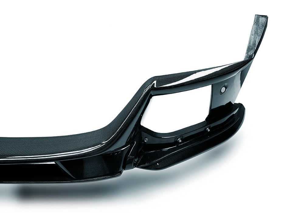 Studio image of Ferrari Purosangue Carbon Fiber Front Lip emphasizing its aerodynamic shape and lightweight design