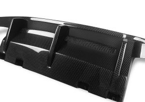Dynamic photo capturing the BMW M2 F87 equipped with the rear diffuser on a track, emphasizing its aerodynamic performance improvements