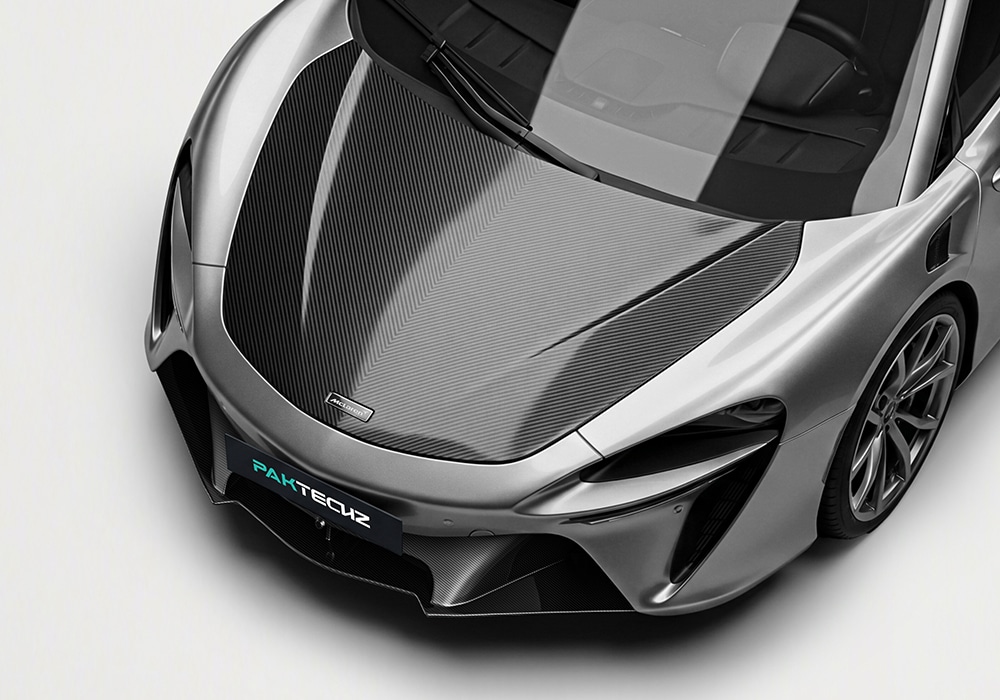 Close-up of the carbon fiber wing spoiler on the McLaren Artura, emphasizing its aerodynamic design