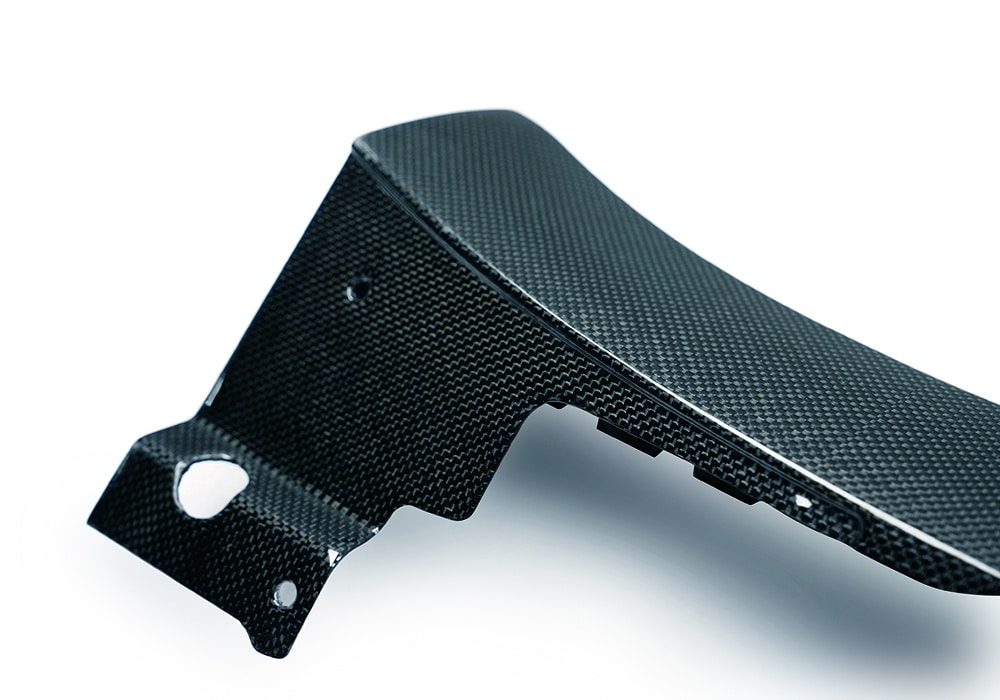 Ferrari Purosangue driving dynamically at speed, showcasing the aerodynamic advantages of the Carbon Fiber Side Skirts