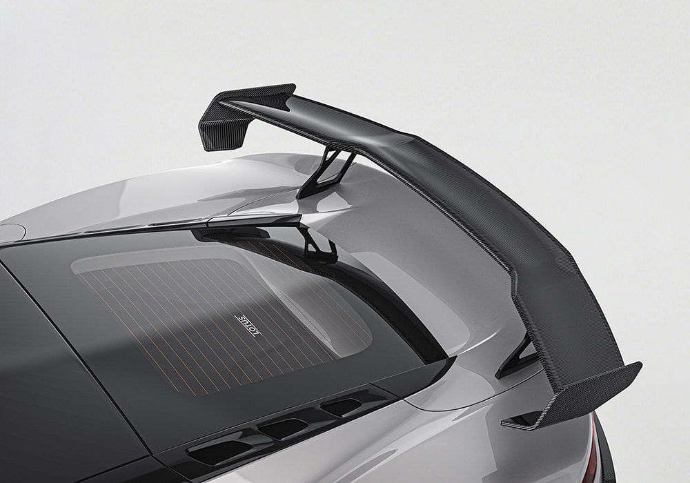 Lotus Emira equipped with a Carbon Fiber Aero Kit showcased in an exhibition, highlighting its refined, race-inspired design