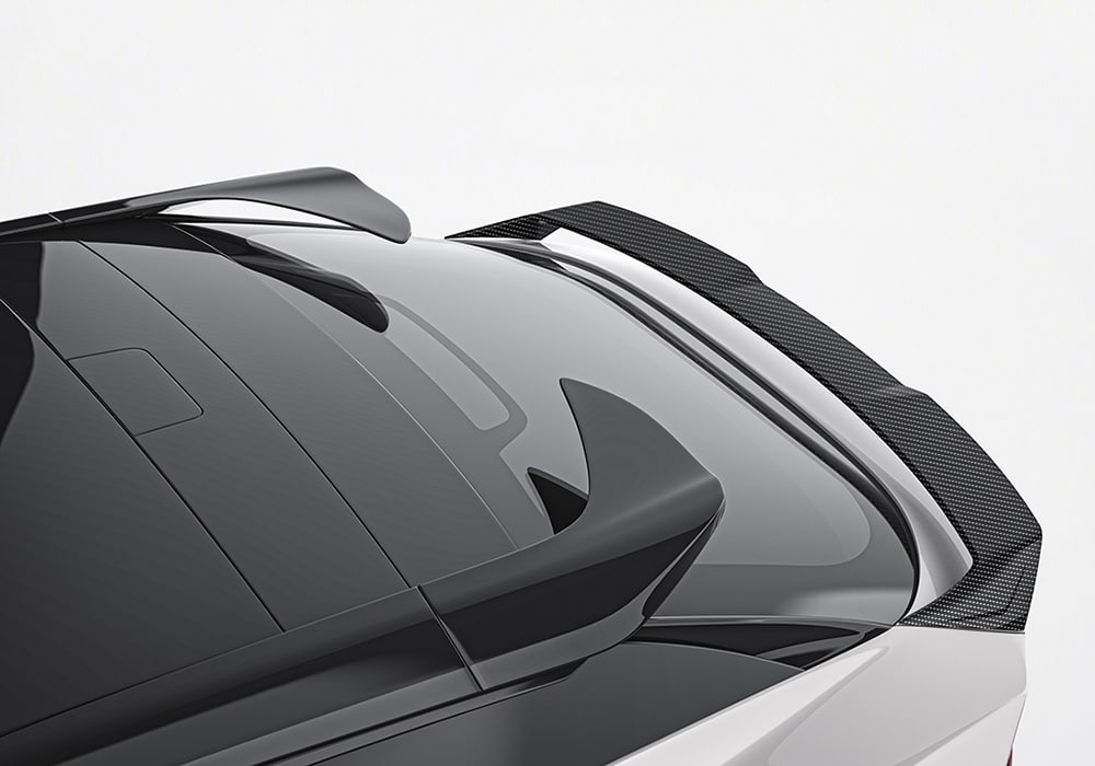 Lotus Eletre on display with a striking Carbon Fiber Aero Kit under bright lights, emphasizing its sporty elegance