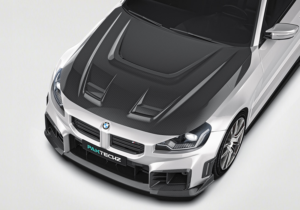 Split-panel showing the factory BMW M2 G87 versus the upgraded, aggressive appearance with the Carbon Fiber Aerodynamic Body Kit installed