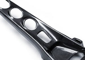 Ferrari F8 interior featuring a Carbon Fiber Center Console Bridge at a car event, capturing attention with its sleek design