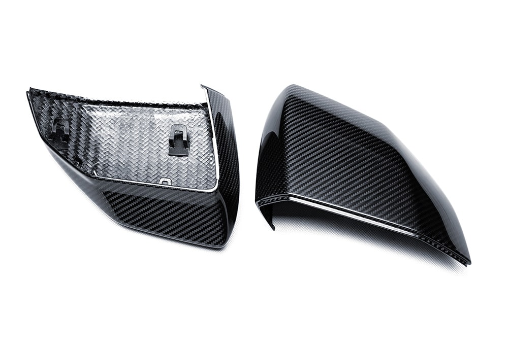 Lamborghini Revuelto in motion with Carbon Fiber Mirror Covers, highlighting road presence and detail