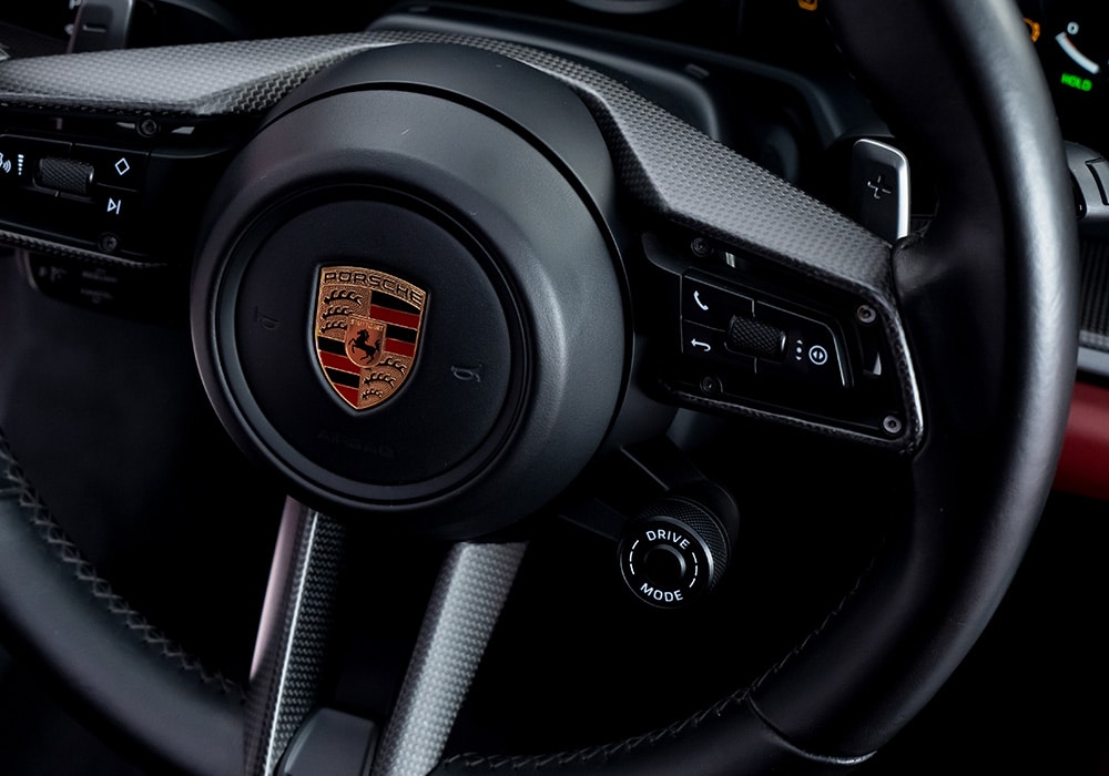 Full view of the Porsche 911 992.2 interior showcasing sleek carbon fiber trims across the dashboard, doors, and center console