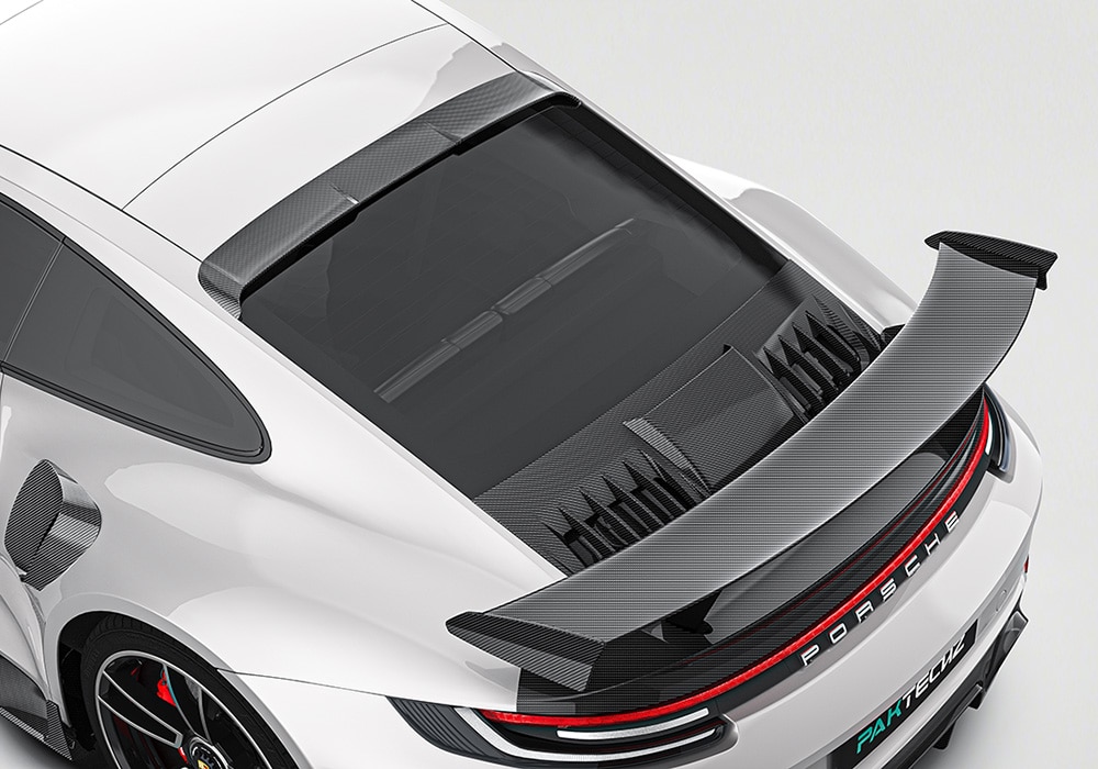 The Porsche 992 Turbo S featuring the full Carbon Fiber Aero Kit, showcasing its aggressive styling upgrades including the front lip and side skirts