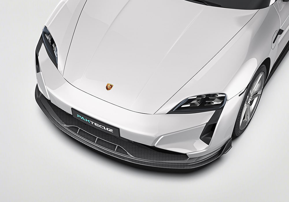 A complete shot of the 2025 Porsche Taycan outfitted with the Carbon Fiber Aero Kit, showing all components such as the front splitter, rear diffuser, side skirts, and roof spoiler