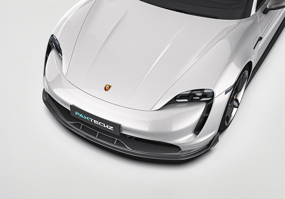 A complete visual showing the Carbon Fiber Aero Kit (front lip, side skirts, rear diffuser, rear spoiler) installed on the Taycan, showcasing its aggressive styling and aerodynamic refinement