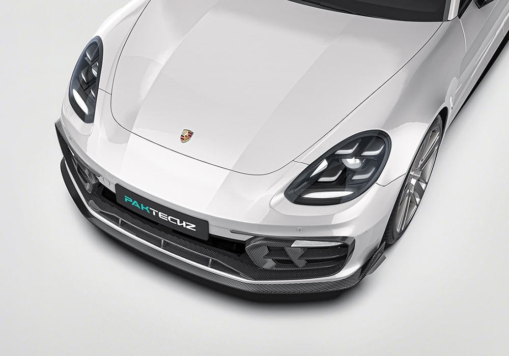 A full side view showcasing all components of the Carbon Fiber Aero Kit, including the front splitter, side skirts, rear diffuser, and rear spoiler, fully integrated into the Porsche Panamera's bodywork