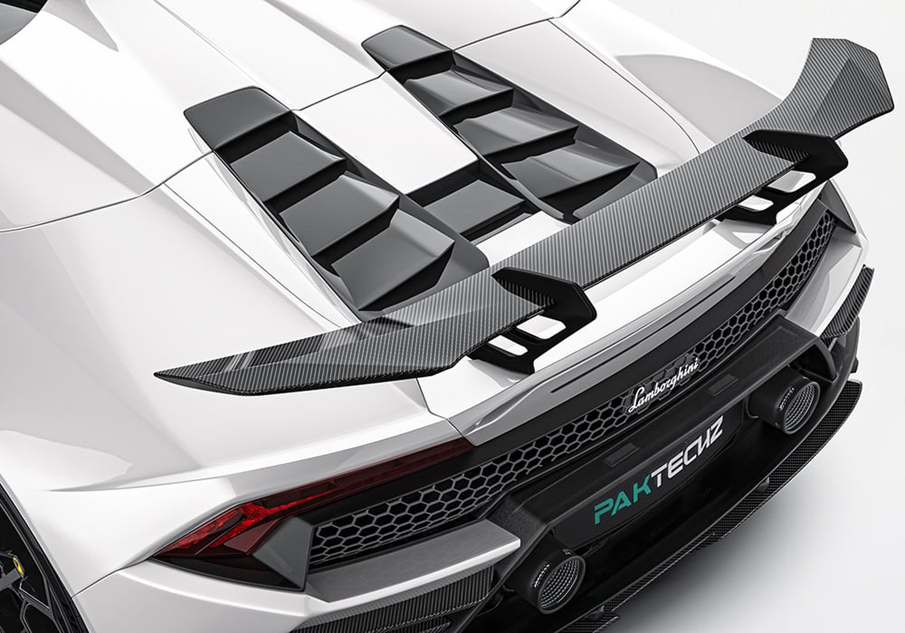 Dynamic shot highlighting the aerodynamic front splitter, seamlessly integrated into the bold curves of the Huracan EVO