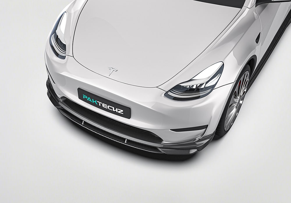 A Tesla Model Y with the Carbon Fiber Aero Kit installed, highlighting the cohesive integration between the front lip, side skirts, spoiler, and rear diffuser