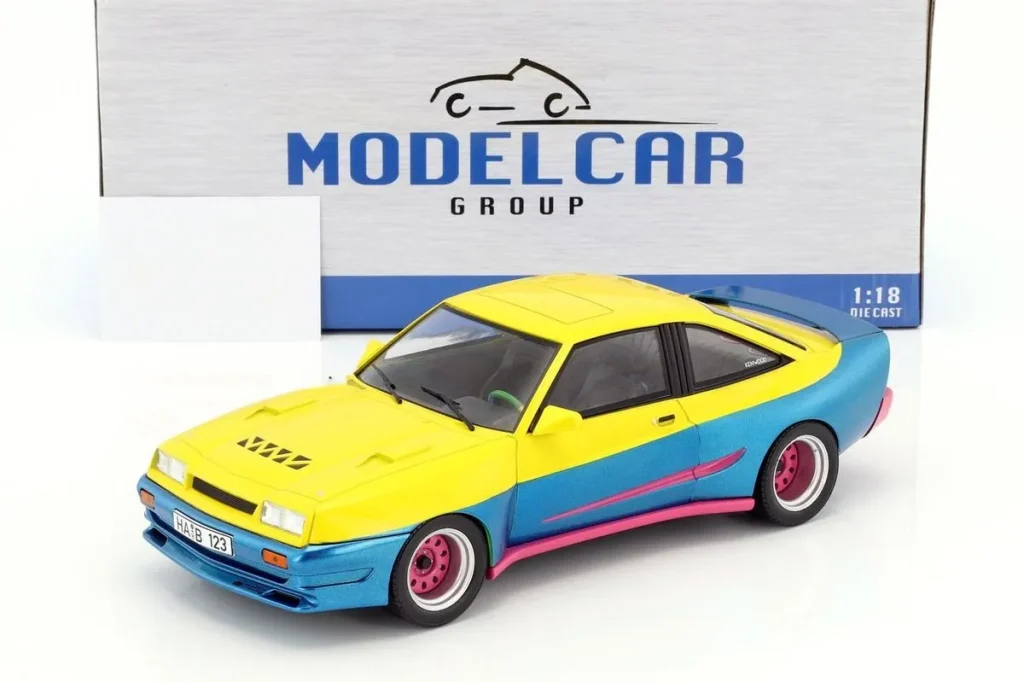 โมเดลรถ 1:18 Opel Manta B Mattig Film Manta Manta ( ) ปี 1991 สีเหลือง / น้ำเงินเมทัลลิก / ชมพู ModelCarGroup
